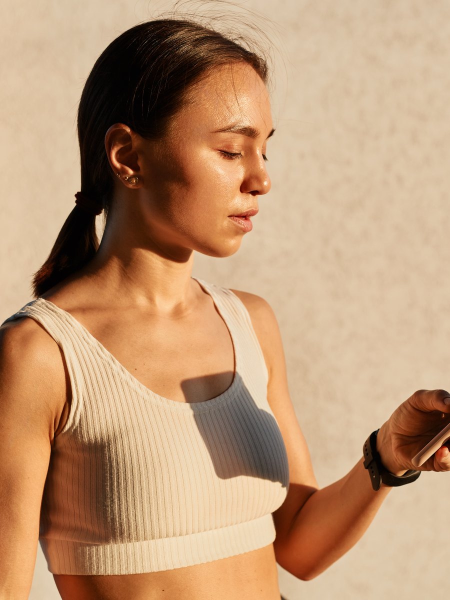 An athlete reading her session back on her phone